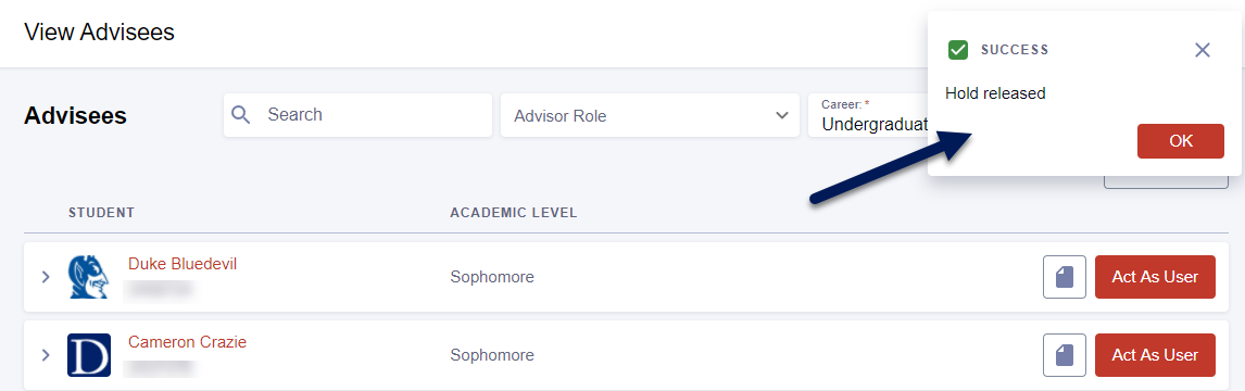 Screenshot of View Advisees page in DukeHub. An arrow points to a message that says, "Success. Hold released."